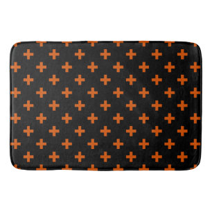 Orange polka crosses on black bath mat