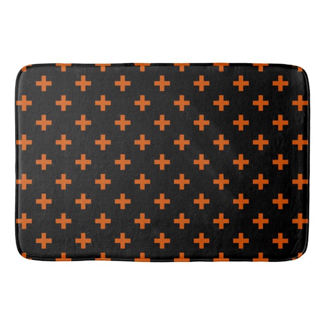 Orange polka crosses on black bath mat (Front)