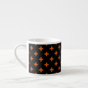 Orange polka crosses on black espresso cup