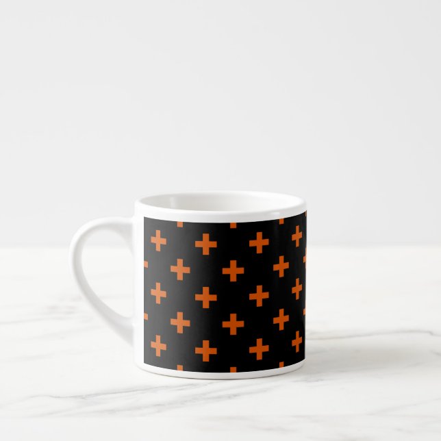 Orange polka crosses on black espresso cup (Left)