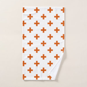 Orange polka crosses on white hand towel