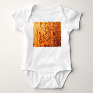 Orange raindrops on glass, abstract background. baby bodysuit