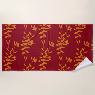 Orange silhouette branch leaves on red beach towel