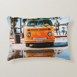 Orange van with surfboard on top accent pillow