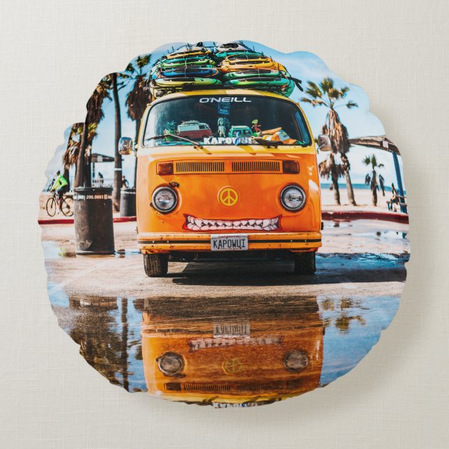 Orange van with surfboard on top round pillow (Front)