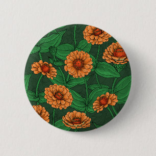 Orange Zinnia flowers, green leaves on dark green 2 Inch Round Button