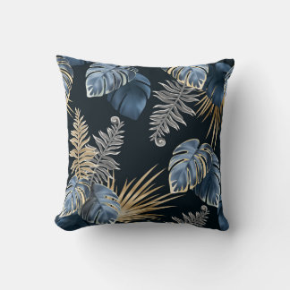 oreiller jeté avec feuilles sombres de plantes tro