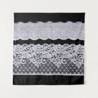 Ornamental white lace, isolated black background.