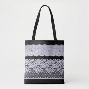 Ornamental white lace, isolated black background. tote bag