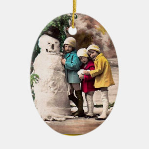 ORNEMENT OVALE EN CÉRAMIQUE LES ENFANTS AVEC LA NEIGE