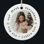 Our First Christmas as Big Sister & Bro Photo Ceramic Ornament<br><div class="desc">Celebrate a sweet first Christmas for the new siblings. This round photo ornament features a cozy kraft-paper look,  curved “our first christmas” text,  and a portrait window perfect for a big sister holding her baby brother. Ideal for newborn season photos,  family gifting,  and keepsake tree decor.</div>