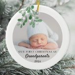 Our First Christmas As Grandparents Foliage Photo  Ceramic Ornament<br><div class="desc">This Grandparent's First Christmas Ornament is decorated with green watercolor mistletoe. Easily customizable with your baby's photo, name, and year. Use the Design Tool to change the text size, style, or colour. Because we create our artwork you won't find this exact image from other designers. Original Watercolor © Michele Davies....</div>