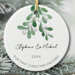 Our First Christmas Engaged Mistletoe Ceramic Ornament<br><div class="desc">Celebrate your first Christmas as an engaged couple with this stylish ceramic ornament. 
It is decorated with watercolor mistletoe and elegant script typography.
Easily customizable.
Use the Design Tool to change the text size,  style,  or colour.
Original Watercolor © Michele Davies.</div>