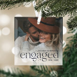 Our First Christmas Engaged Personalized Photo Glass Ornament<br><div class="desc">An elegant keepsake of your engagement year,  this beautiful glass ornament displays a favourite photo with "our first Christmas engaged" overlaid in dark navy blue lettering accented with stars. Personalize with your initials and the year.</div>