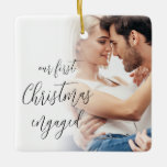 Our First Christmas Engaged Script Photo Names Ceramic Ornament<br><div class="desc">Our First Christmas Engaged Script Custom Photo Names. A fully customisable design especially to celebrate the happy couple’s first Christmas after their engagement and memento for the tree in Christmasses to come.. A beautiful calligraphy script for the text on the front and names on the back. Easily personalise with your...</div>