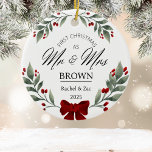 Our First Christmas Mr and Mrs Greenery Watercolor Ceramic Ornament<br><div class="desc">Celebrate your first holiday as a married couple with our Mr. and Mrs. Our First Christmas Ornament. Set against a white background, this elegant ornament features beautiful botanical holly berries, delicate greenery, and charming watercolor florals. Personalize it with your names and wedding date to create a timeless keepsake that will...</div>