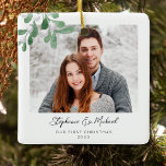 Our First Christmas Photo Ceramic Ornament<br><div class="desc">This First Christmas Photo Ornament is decorated with watercolor mistletoe and stylish script typography. Easily customizable with your photo, name, and year. Use the Design Tool to change the text size, style, or colour. Because we create our artwork you won't find this exact image from other designers. Original Watercolor ©...</div>