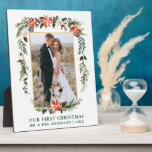 Our First Christmas Watercolor Poinsettia Photo Plaque<br><div class="desc">Elegant Watercolor Poinsettias Our First Christmas Newlywed Wedding Photo Plaque includes beautiful watercolor red poinsettias,  botanical greenery,  winter foliage,  holly berries,  white roses,  cotton,  pine cones and blue berries.  Gold Frame. Green Text.</div>