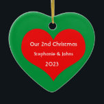 Our Second Christmas Together Cute Red Heart 2023 Ceramic Ornament<br><div class="desc">Personalized names and printed with cute red heart design in solid green background. Feel free to customize by adding your own texts,  names or photos. You can add your photo on the back side of the ornament easily!
The colour of the background can also be changed as you want.</div>