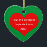Our Second Christmas Together Cute Red Heart 2023 Ceramic Ornament<br><div class="desc">Personalized names and printed with cute red heart design in solid green background. Feel free to customize by adding your own texts,  names or photos. You can add your photo on the back side of the ornament easily!
The colour of the background can also be changed as you want.</div>