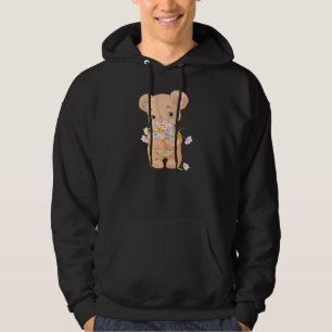 Ours de nounours tenant un sweat - shirt à capuch