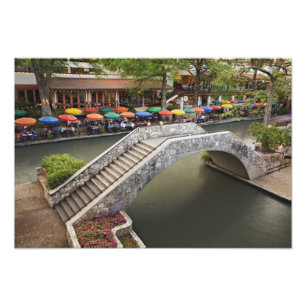 Outdoor cafe along River Walk and bridge over Photo Print