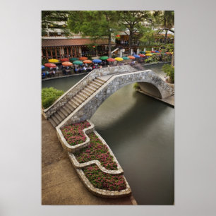 Outdoor cafe along River Walk and bridge over Poster