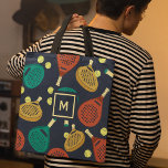 Padel Rackets Pattern with Initial Tote Bag<br><div class="desc">This tote bag is ready to be customized with your choice of initial and features a pattern of padel tennis rackets and balls in shades of terra cotta,  gold,  teal,  yellow and cream against a navy blue background.</div>