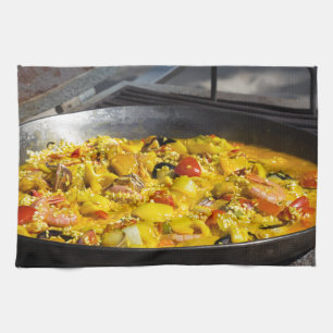 Paella is cooked on a grill kitchen towel