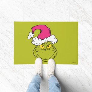 Paillasson Le Grinch avec un chapeau de Père Noël rose