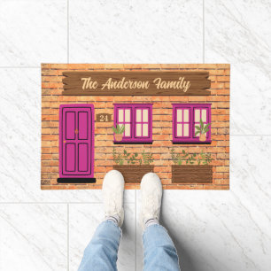 Paillasson Maison en briques avec porte rose Texte personnali