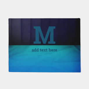 Paillasson Monogramme bleu ombre dénudé texturé