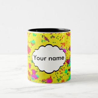 Paint splashes on a yellow background Two-Tone coffee mug