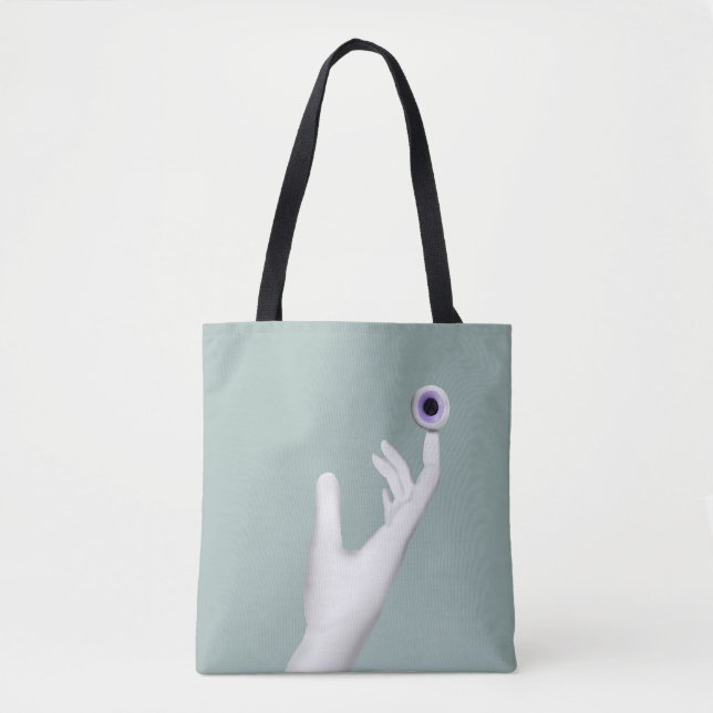 Pale hand holding eye tote bag (Front)
