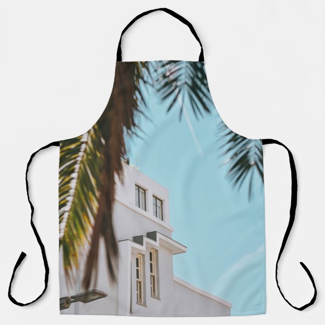 Palm tree near white concrete building apron (Front)