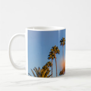 Palm tree under blue sky coffee mug