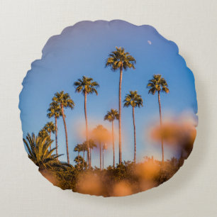 Palm tree under blue sky round pillow