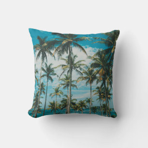 Palm trees above the ocean, vintage toned and retr throw pillow