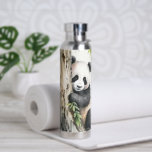 Panda Bear By Tree Water Bottle<br><div class="desc">Cute panda bear by a tree with bamboo leaves in watercolor artwork.</div>