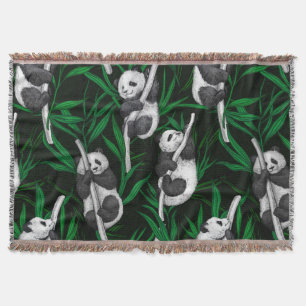 Panda cubs on dark green throw blanket