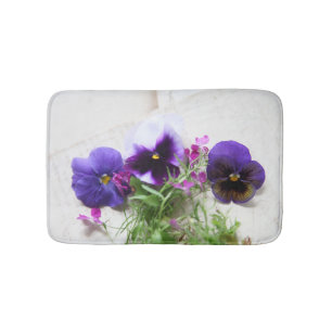 Pansies and lobelia on old handwriting bath mat