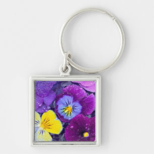 Pansy flowers floating in bird bath with dew keychain