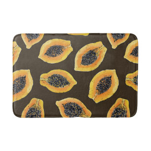 Papaya slices on dark brown bath mat
