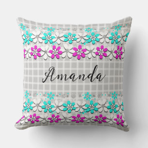 Paper neon flowers on a grey-white chequered throw pillow