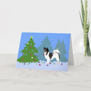 Papillon Dog Decorating Christmas Tree in Forest Holiday Card