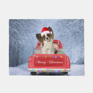 Papillon Dog in Snow sitting in Christmas Truck Doormat