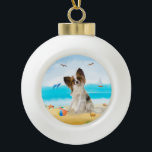 papillon Dog on Beach Ceramic Ball Christmas Ornament<br><div class="desc">A papillon dog sitting on beach is a perfect gift idea for someone who love this dog breed.</div>