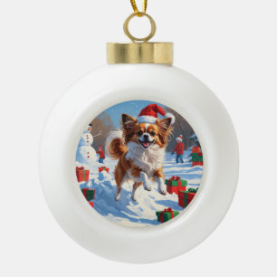 Papillon Dog Running in Snow with Christmas Hat Ceramic Ball Christmas Ornament
