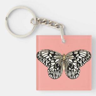 Papillon noir et blanc, fond rose corail