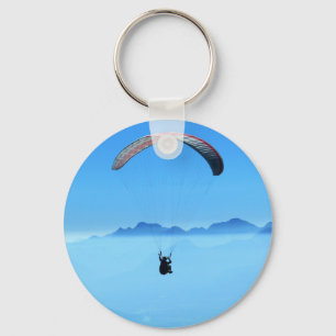 Paraglider on blue background with mountains keychain